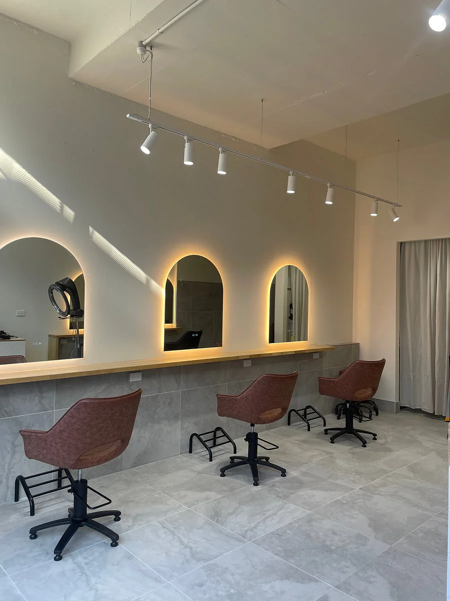 Tiff Hair Salon — arched back-lit mirrors and warm interior, St Kilda