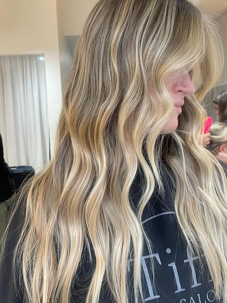 Blonde balayage result at Tiff Hair, client in Tiff Hair Salon cape