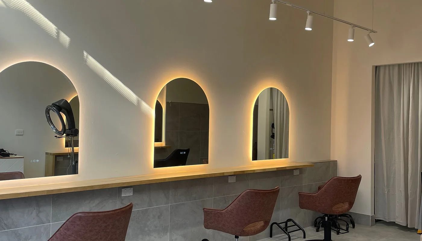 Tiff Hair Salon studio — arched back-lit mirrors, terracotta styling chairs, St Kilda