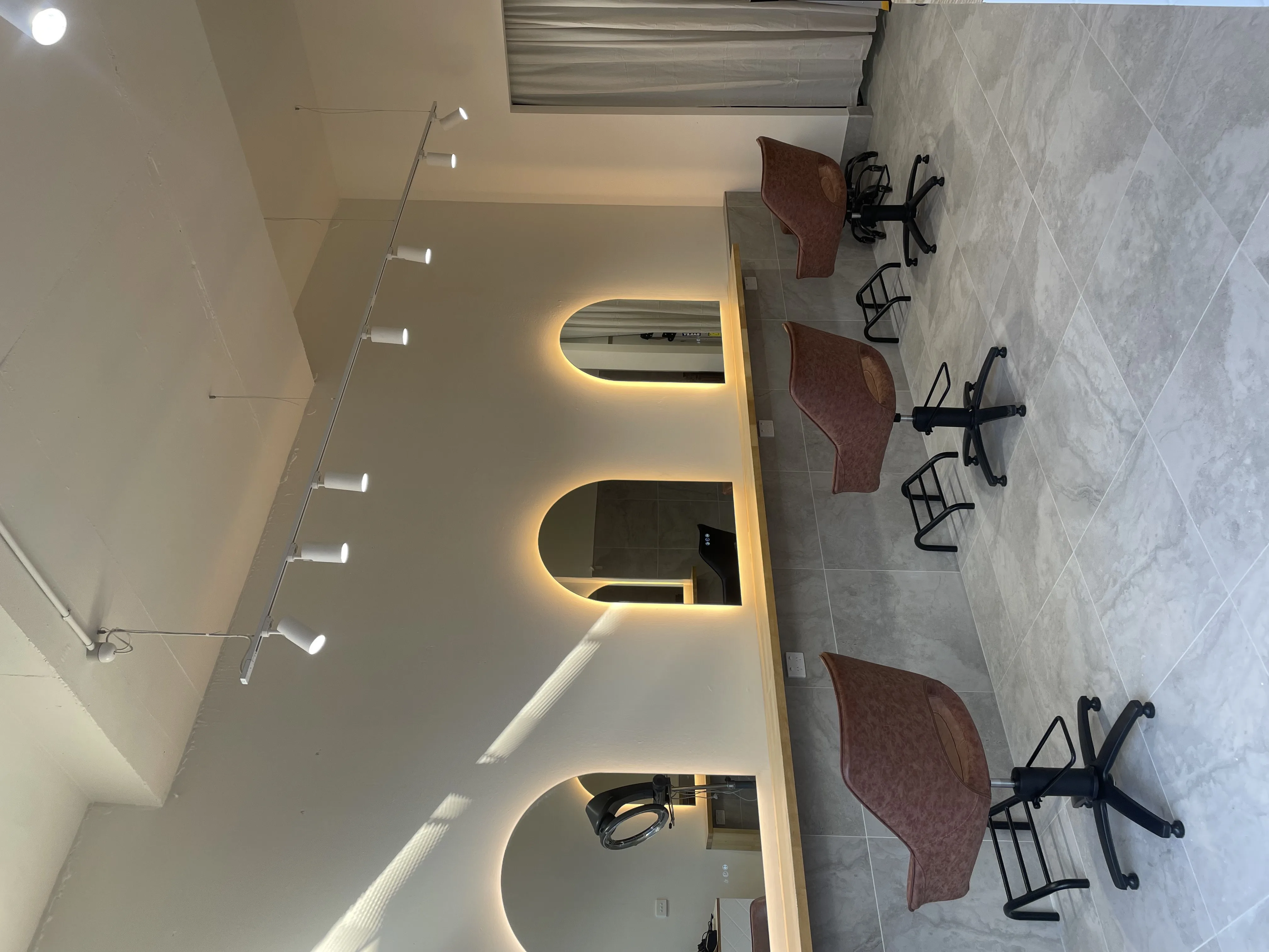 Tiff Hair salon interior — arched backlit mirrors, St Kilda